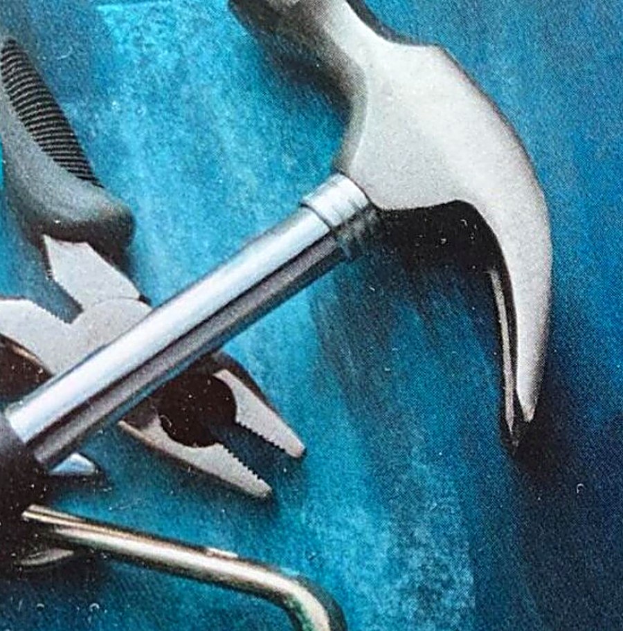 Professional hand tools — claw hammer, pliers and wrench — ready for home repair work